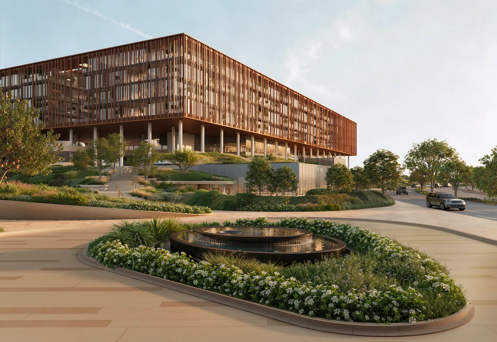 The Yards Plaza drop-off: a planted roundabout before the louvred façade